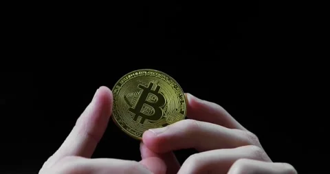Bitcoin displayed on black background for finance and fintech concepts, fingers Stock Footage 295331902