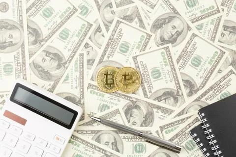 Bitcoin on a dollar background. Stock Photos