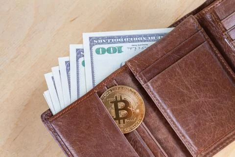 Bitcoin with dollars in brown wallet, virtual cryptocurrency trading and inve Stock Photos