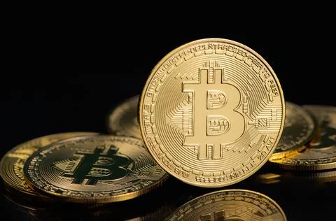 Bitcoin e-cryptocurrency on black background. Stock Photos
