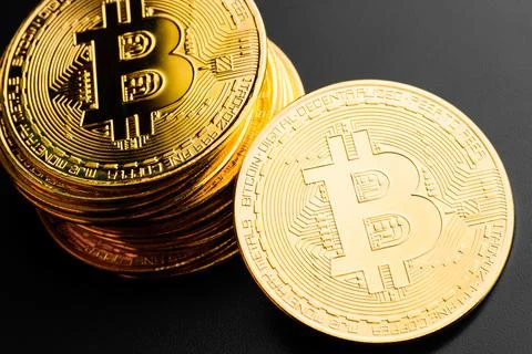 Bitcoin e-cryptocurrency on black background Stock Photos