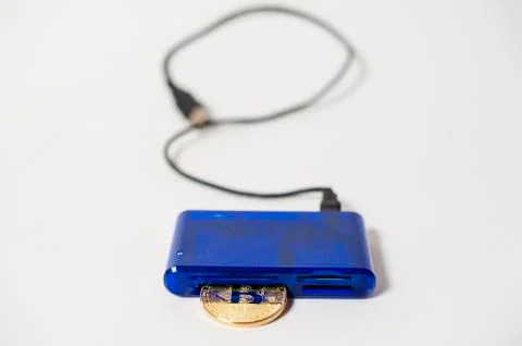Bitcoin electronic coin inside a digital card reader, white background Stock Photos
