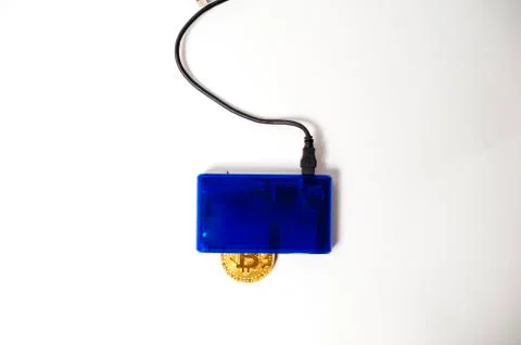 Bitcoin electronic coin inside a digital card reader, white background Stock Photos