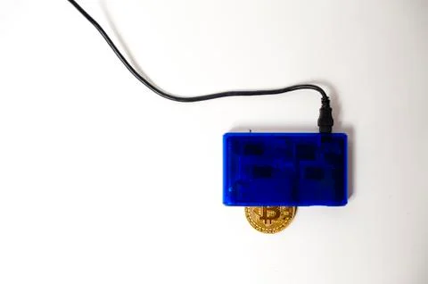 Bitcoin electronic coin inside a digital card reader, white background Stock Photos