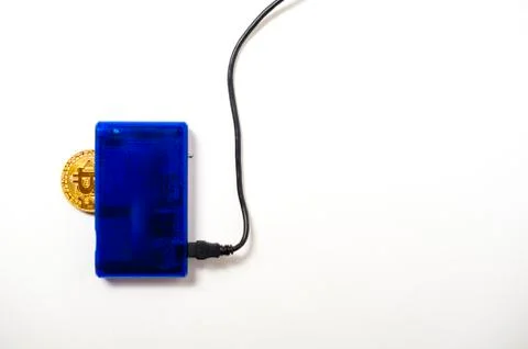 Bitcoin electronic coin inside a digital card reader, white background Stock Photos