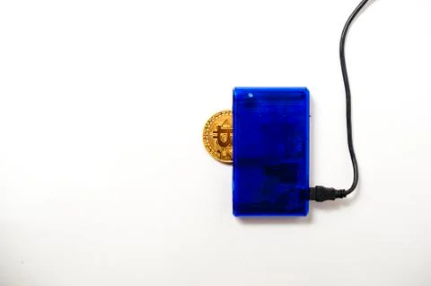Bitcoin electronic coin inside a digital card reader, white background Stock Photos