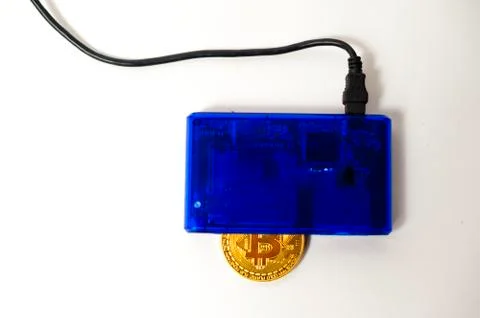 Bitcoin electronic coin inside a digital card reader, white background Stock Photos