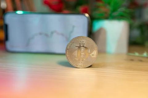 Bitcoin gold coin - crypto chart on a smartphone - cryptocurrency concept Stock Photos