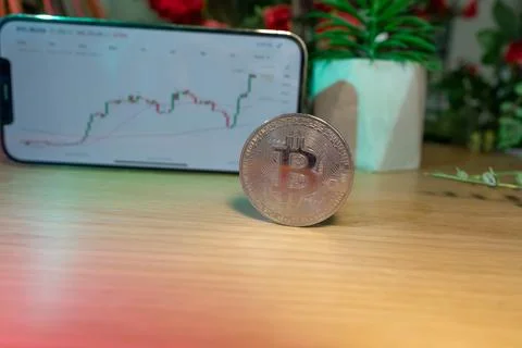 Bitcoin gold coin - crypto chart on a smartphone - cryptocurrency concept Stock Photos