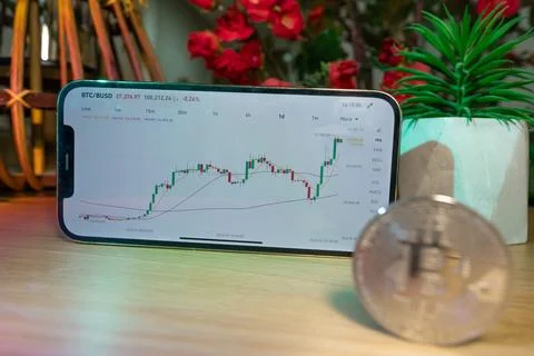 Bitcoin gold coin - crypto chart on a smartphone - cryptocurrency concept Stock Photos