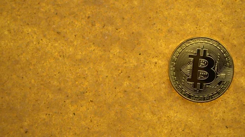 Bitcoin on golden sand Stock-Footage 111302372