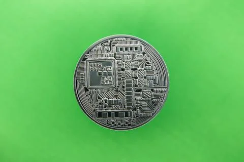 A Bitcoin on green background Stock Photos