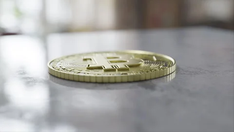Bitcoin on a grey table Stock Footage 253588697