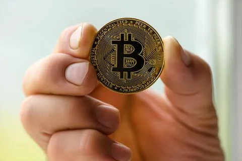 Bitcoin in hand closeup Stock Photos