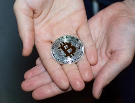 Bitcoin in hands Stock Photos