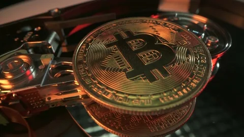 Bitcoin on hard drive disk as mining concept. Macro shot. Crypto currency Gold Stock Footage 144247191