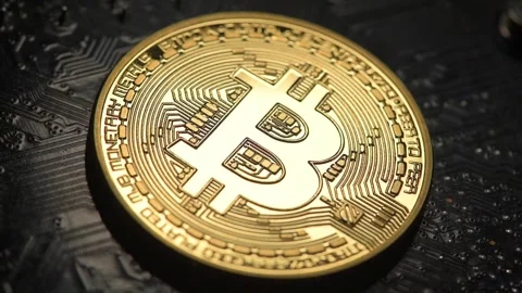 Bitcoin illuminated over a silicon computer chip Stock Footage 192067835