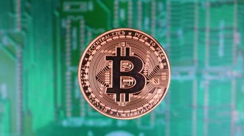 Bitcoin Image, Single Copper Coin, Over Distant PCB Motherboard. Stock Photos