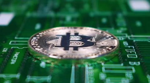 Bitcoin Image, Single Silver Coin, Laying on PCB motherboard. Stock Photos