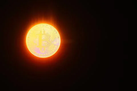 Bitcoin instead a burning sun with black background Stock Photos