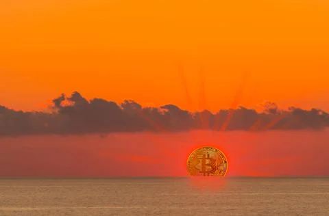 Bitcoin instead a sun with rays three quarters visible on the horizon at the  Foto stock