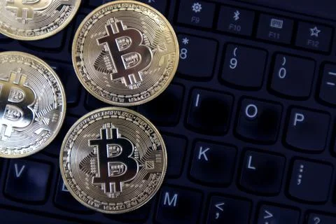 Bitcoin on a laptop keyboard Stock Photos