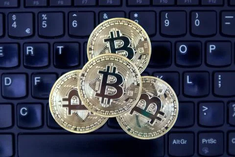 Bitcoin on a laptop keyboard Stock Photos
