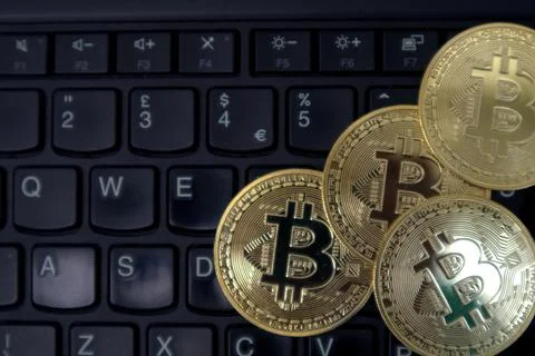 Bitcoin on a laptop keyboard Stock Photos
