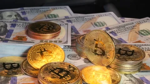 Bitcoin lies on many stacks dollars money on black background, top view. Stock Footage 265485789
