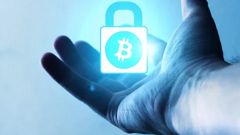 A bitcoin lock that orbits on the palm of a man's hand Stock Footage 97225752
