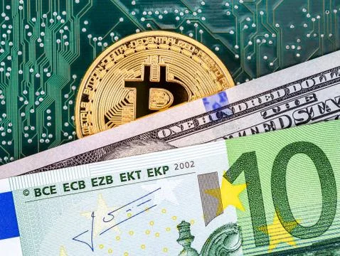 Bitcoin lying over electronic computer component and banknotes Stock Photos
