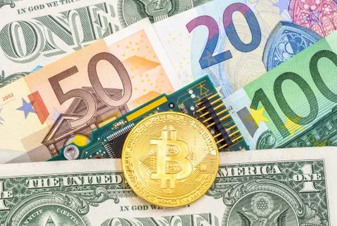 Bitcoin lying over electronic computer component and banknotes Stock Photos