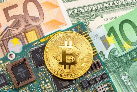 Bitcoin lying over electronic computer component and banknotes Stock Photos