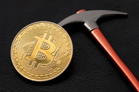 Bitcoin lying on the Pickaxe, BTC Mining Concept Stock Photos