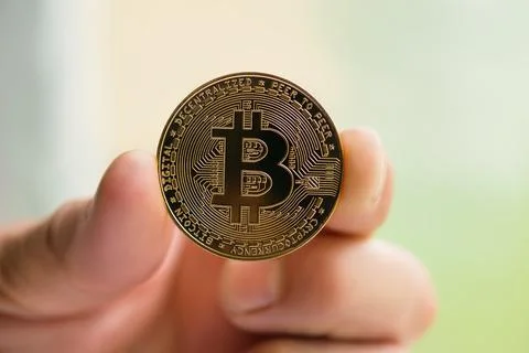 Bitcoin in man hand close up Stock Photos