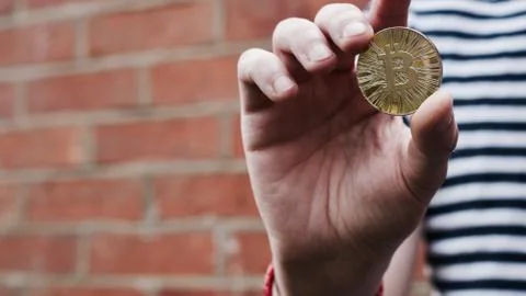 Bitcoin in man hand Stock Photos