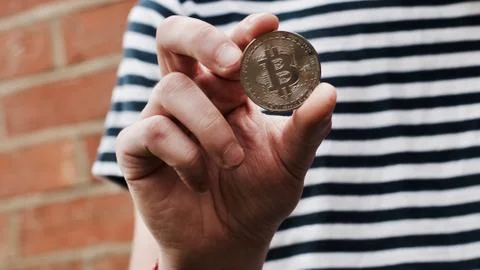 Bitcoin in man hand Stock Photos