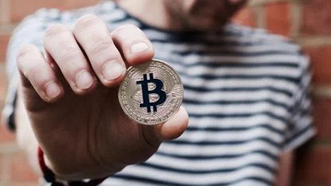 Bitcoin in man hand Stock Photos