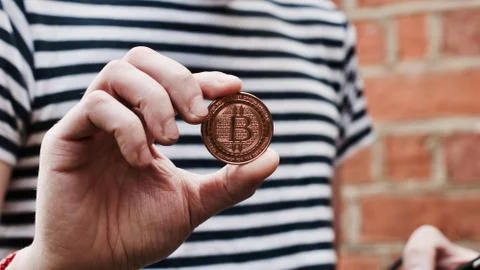 Bitcoin in man hand Stock Photos