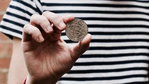 Bitcoin in man hand Stock Photos