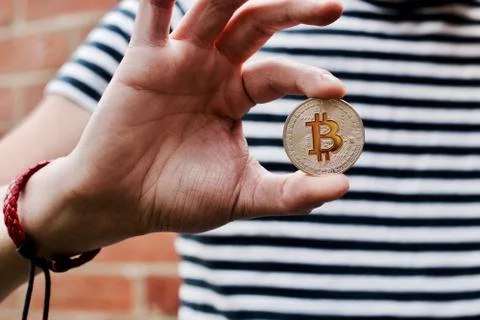 Bitcoin in man hand Stock Photos