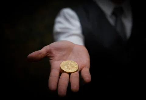 Bitcoin in a man's hand Stock Photos