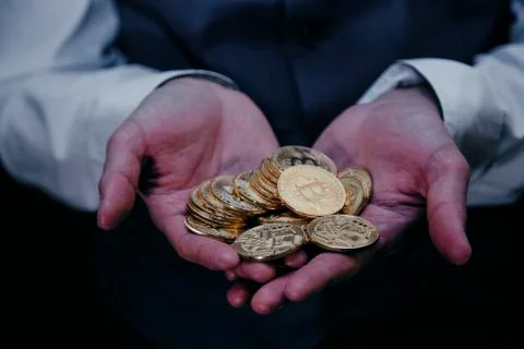 Bitcoin in a man's hand Stock Photos
