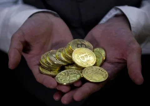 Bitcoin in a man's hand Stock Photos