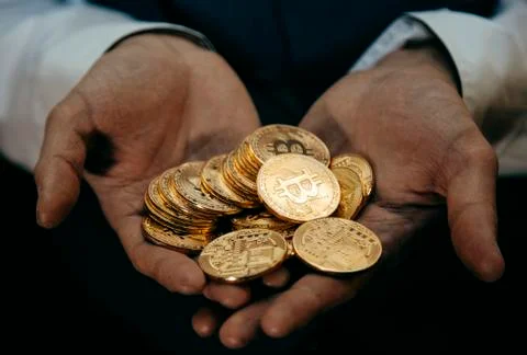 Bitcoin in a man's hand Stock Photos