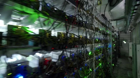 Bitcoin miners in large farm. ASIC mining equipment on stand racks mine Stock Footage 158732870