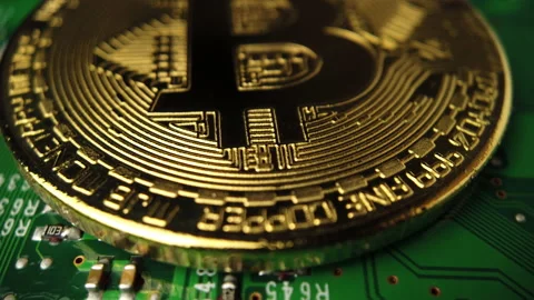 Bitcoin mining concept. The gold coin is located on the printed circuit boar Stock Footage 162671806