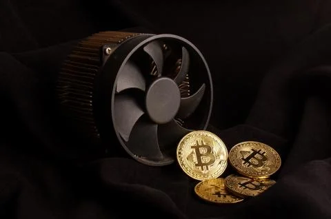 Bitcoin mining device and some golden coins as a profit or mining process Stock Photos