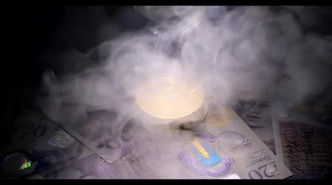 Bitcoin over british pound notes under smoke Stock Photos