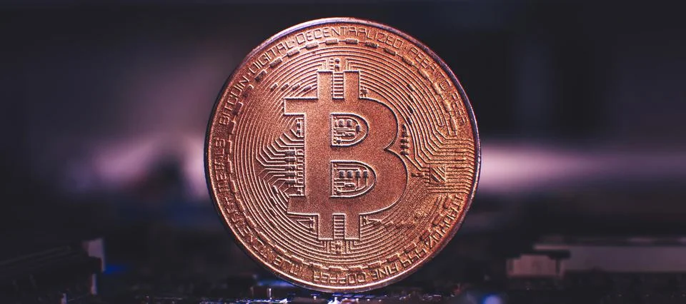 Bitcoin over a microprocessor in a motherboard. With copy space and selective Stock Photos